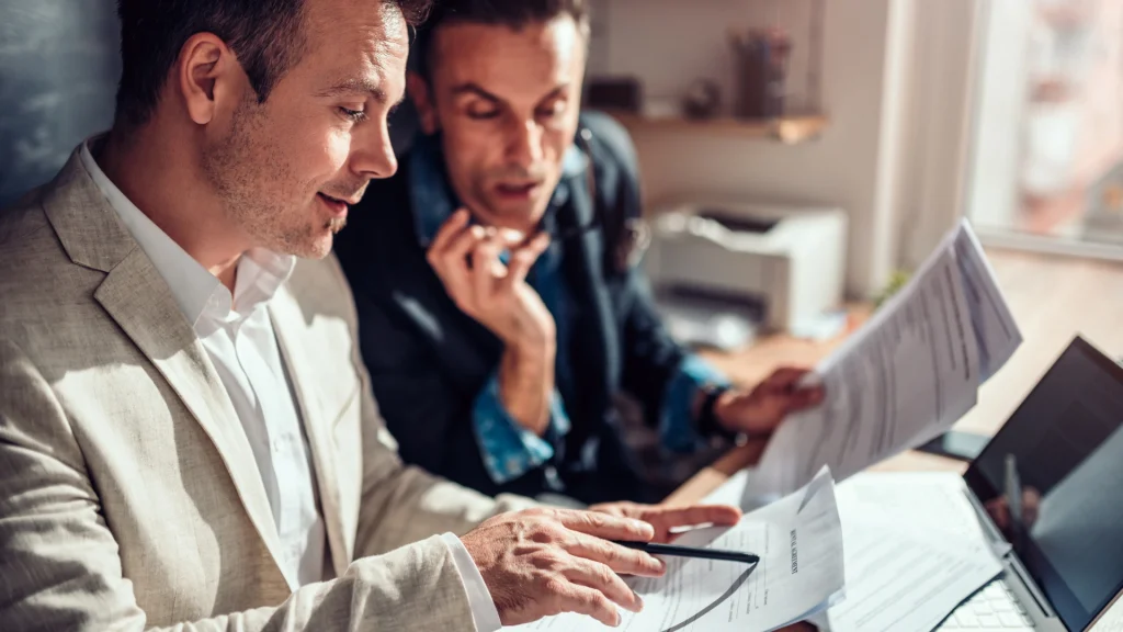 2 loyal customers talking about what is written to a paper