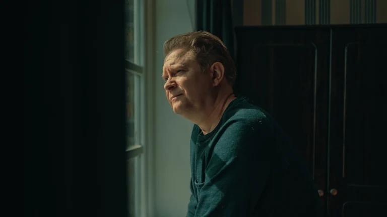 Man looking outside on a window