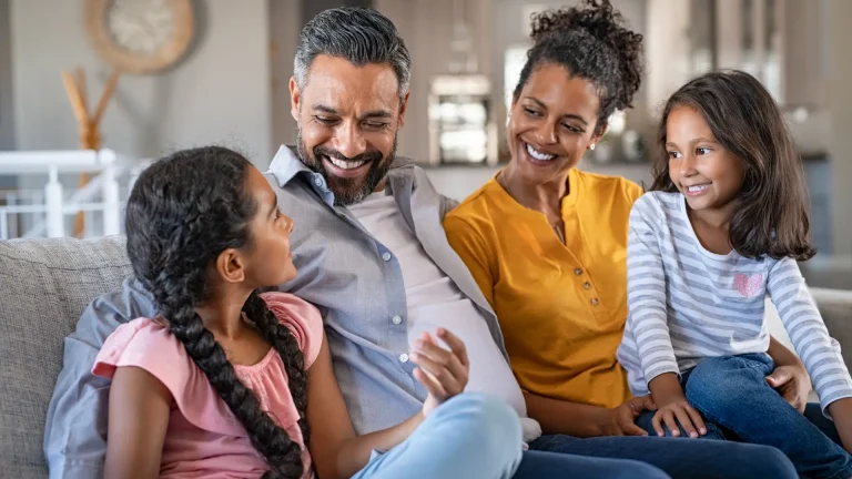 Parents talking with their adult children with smiling faces