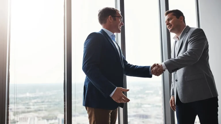 2 people shaking hands having buyouts one of types of business buyers