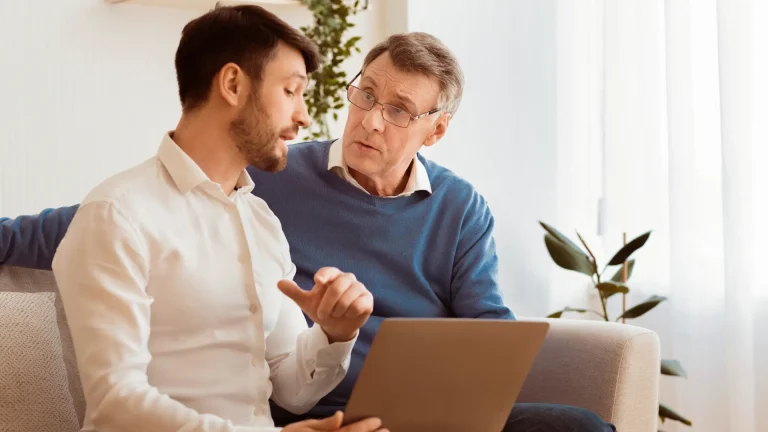 Old man talking to one of his adult children