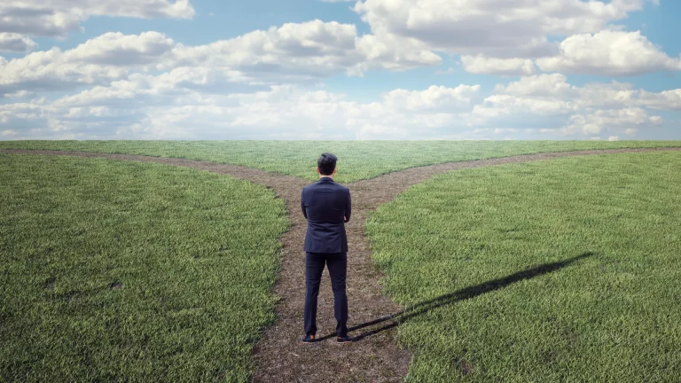 Man standing on cross road showing business mindset