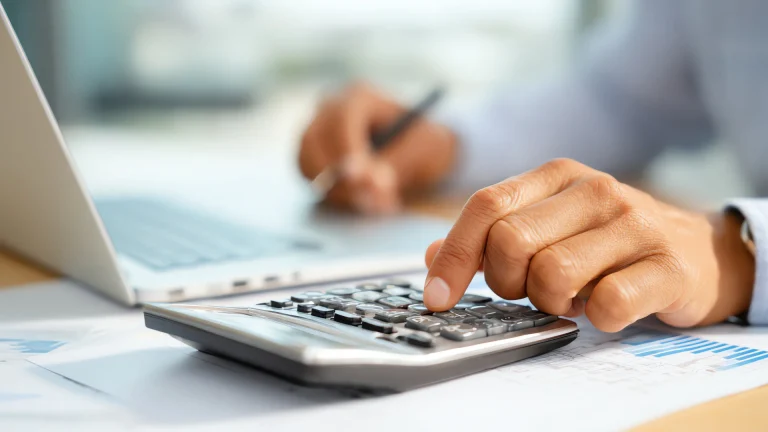 Man doing math on business brokers