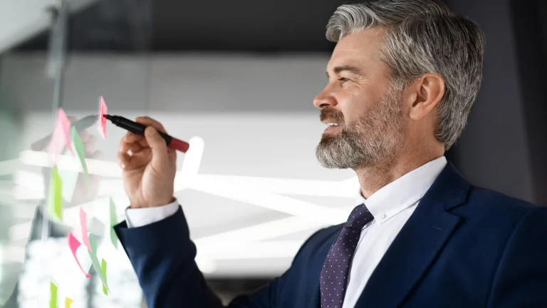 Man writing on board for plans how to sell your business